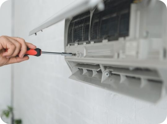 Man repairing wall unit air conditioner