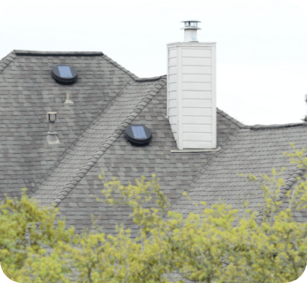 Solar attic fans on top of a house