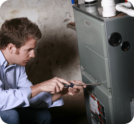 Technician performing maintenance on a furnace